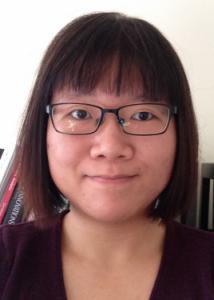 Headshot of Xiao Yang with short dark hair, glasses, and maroon blouse.