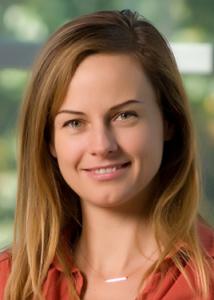 Headshot of Zita Oravecz with long light brown hair and salmon blouse.